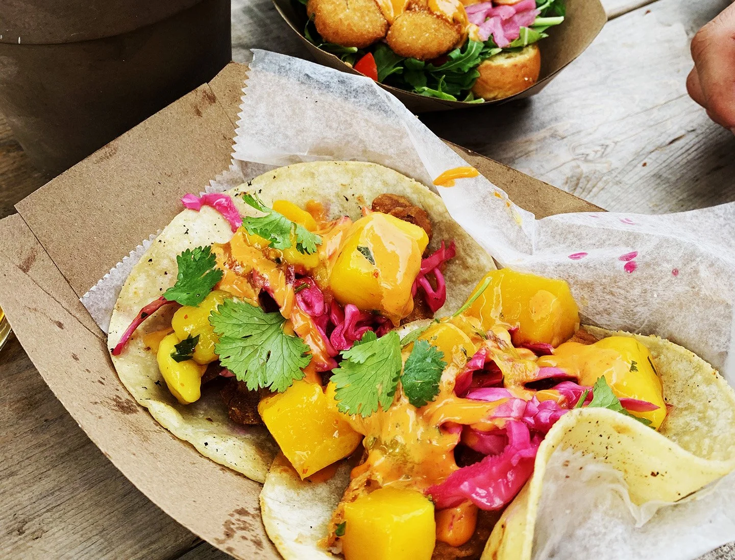 taco with mango chunks and pickled red onion