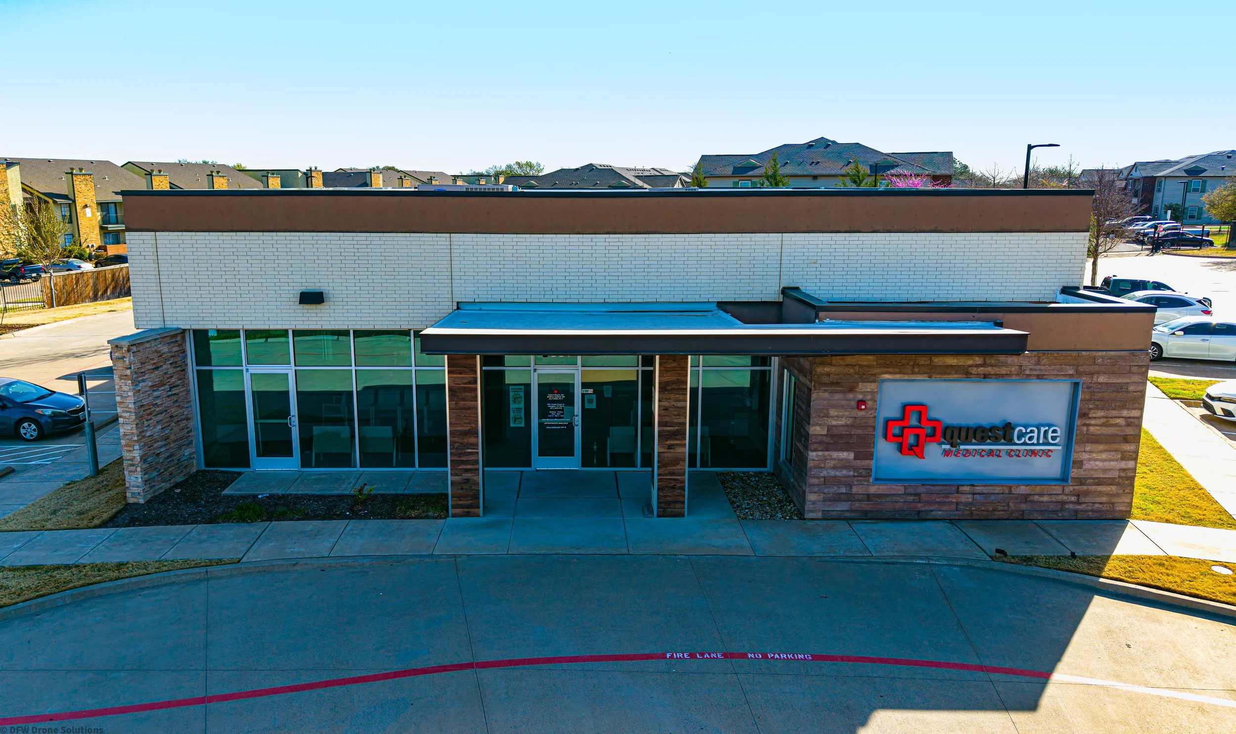 Exterior view of QuestCare Medical Clinic with a visible sign and surrounding parking area.