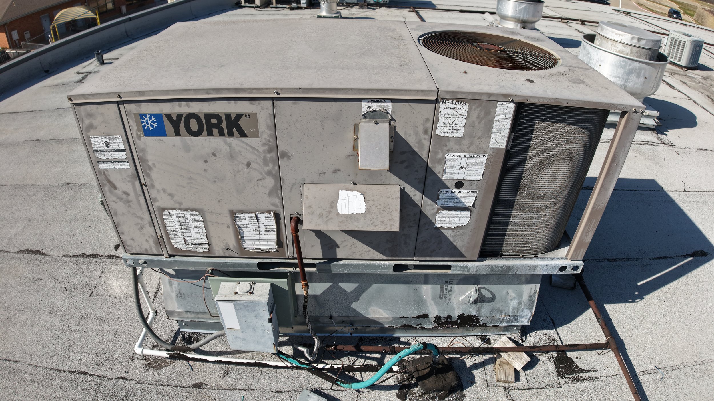 Rooftop HVAC unit on a flat roof with brand logo visible.