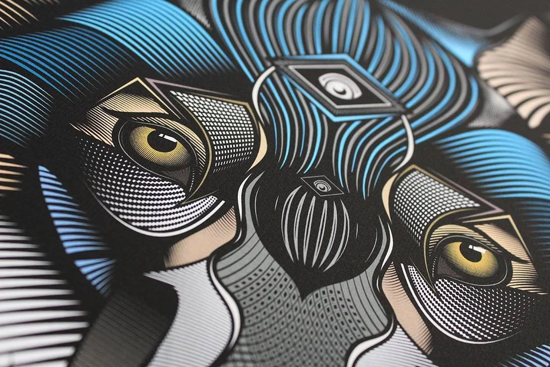 Digital artwork of a face with stylized, geometric patterns and blue, black, and beige colors, featuring prominent eyes and flowing hairlines.