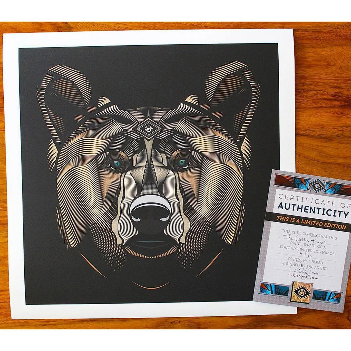 A geometric art print of a wolf's face on black paper, with a certificate of authenticity beside it.