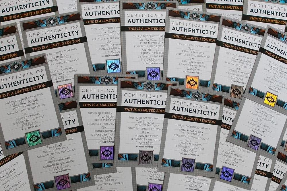 Multiple certificates of authenticity for limited edition prints, featuring colorful holographic seals, arranged in overlapping layers.