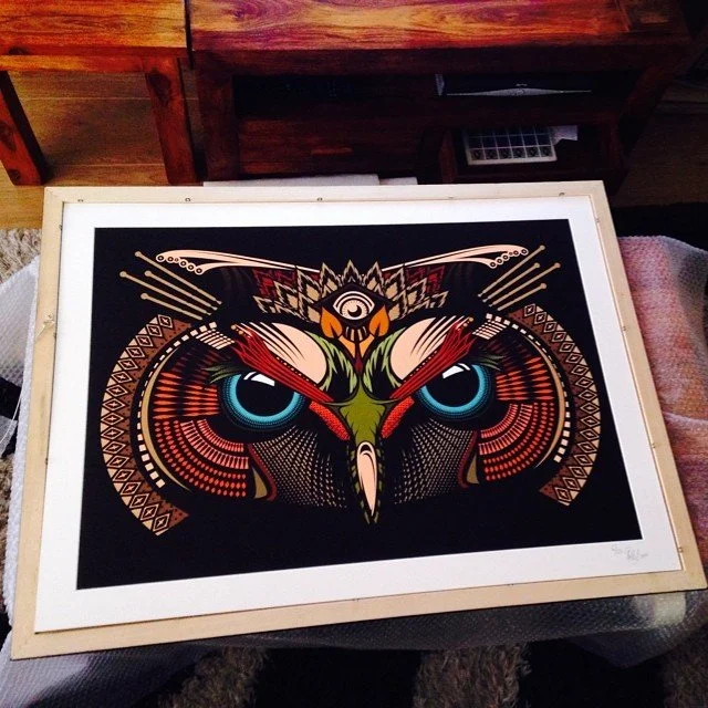 A colorful, stylized illustration of an owl with intricate patterns and vibrant colors, centered on a black background.