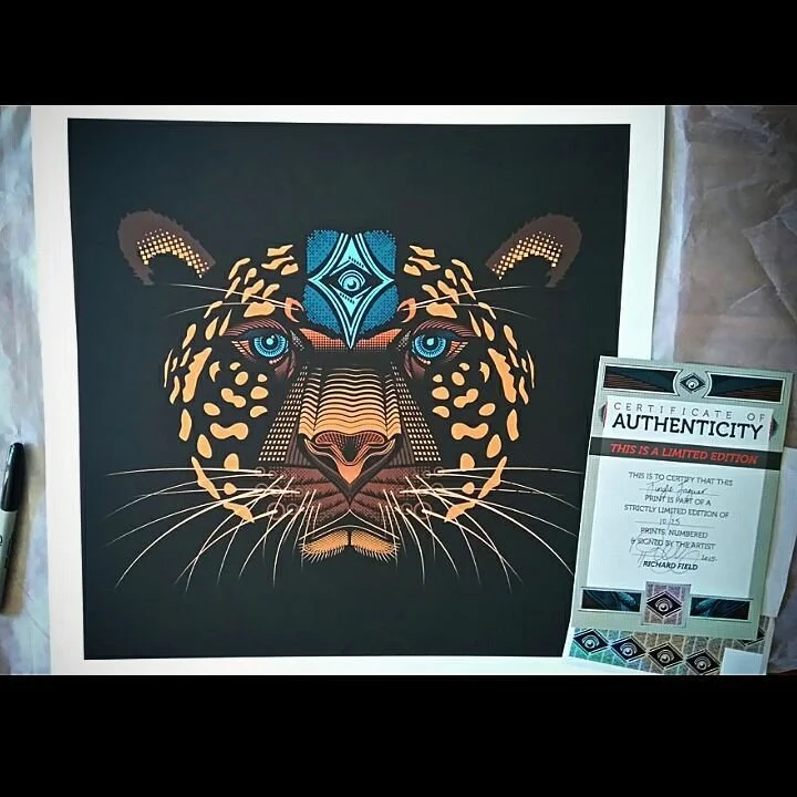 Colorful geometric illustration of a jaguar's face with blue and orange accents, accompanied by a certificate of authenticity.