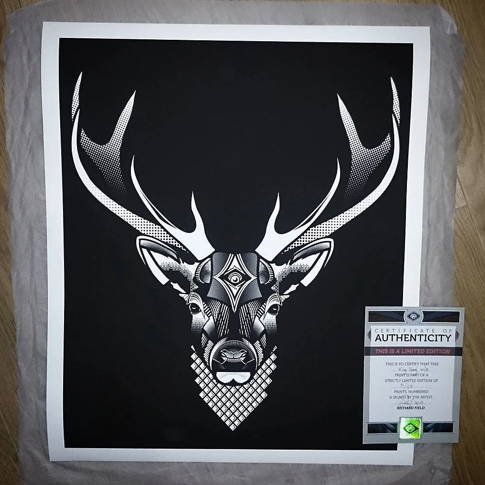 Black and white geometric deer head with antlers in a stylized design on paper, accompanied by an authenticity certificate with a green hologram.