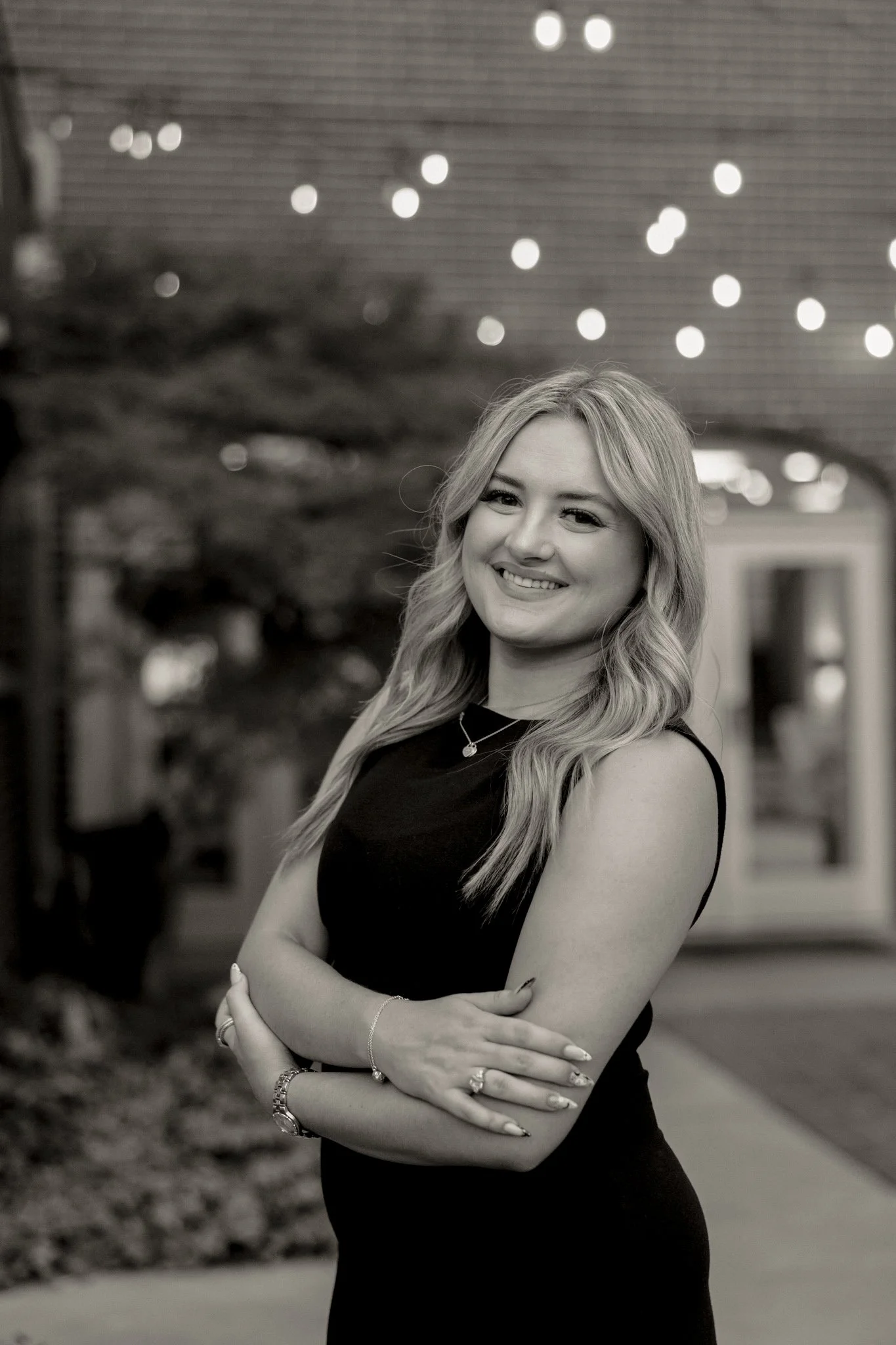 Lauren Tracy, brand and marketing strategist at Soft Sundays, photographed outdoors under string lights.