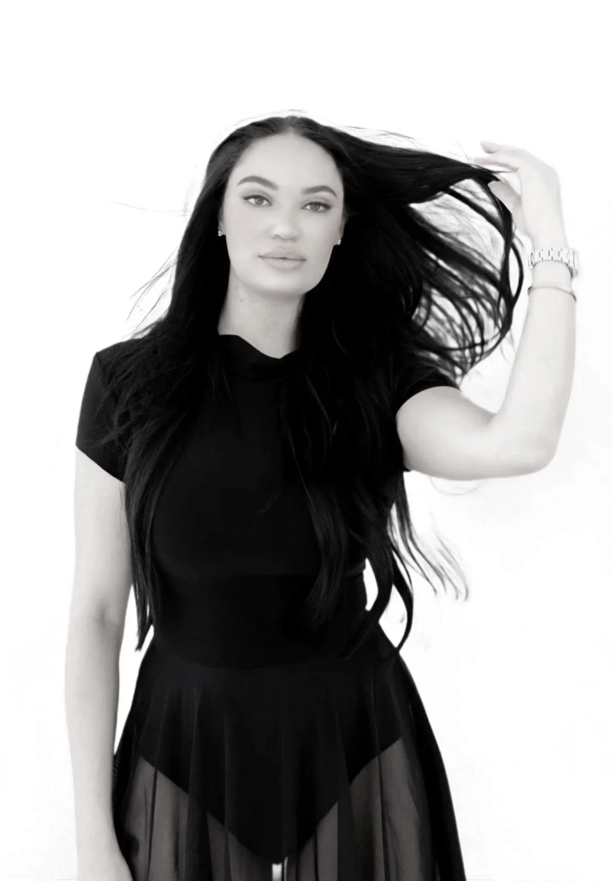 Sophia Tinnucci, founder and lead makeup artist at Soft Sundays, in a black top against a white backdrop.