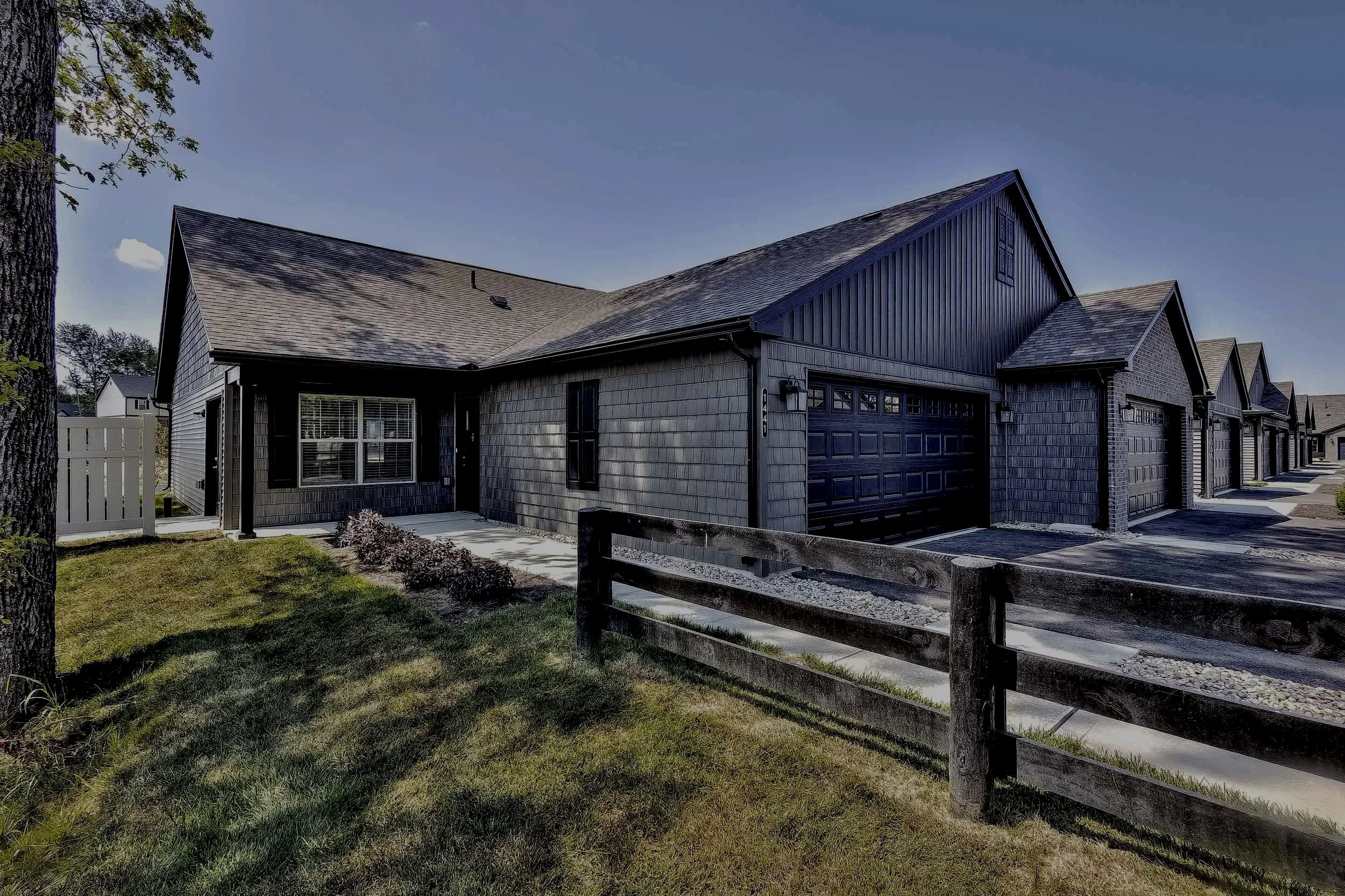 Home rental building featuring a yard with green grass, private driveway, and 2-car sized garage.