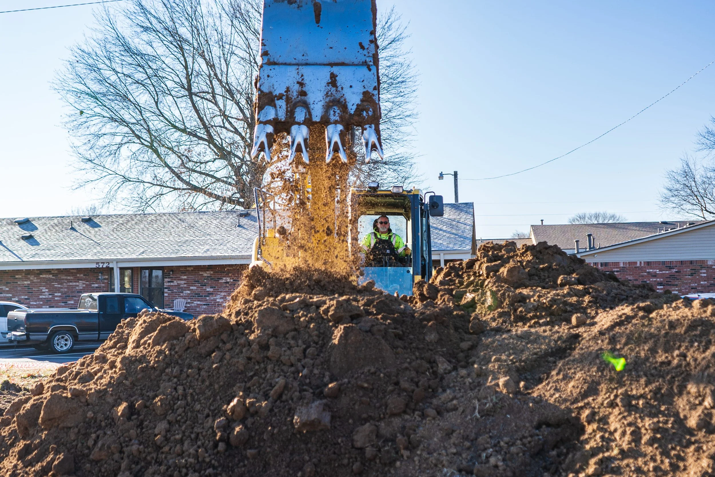 An excavator moving dirt on a job site