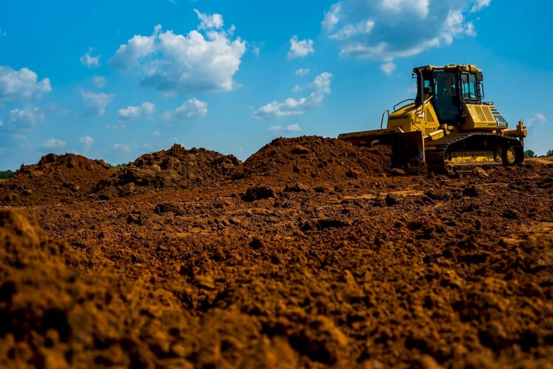 Dozer moving dirt on a job site during a sunny day