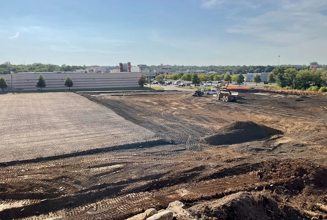 Mass grading and earthwork shown with equipment in the background.