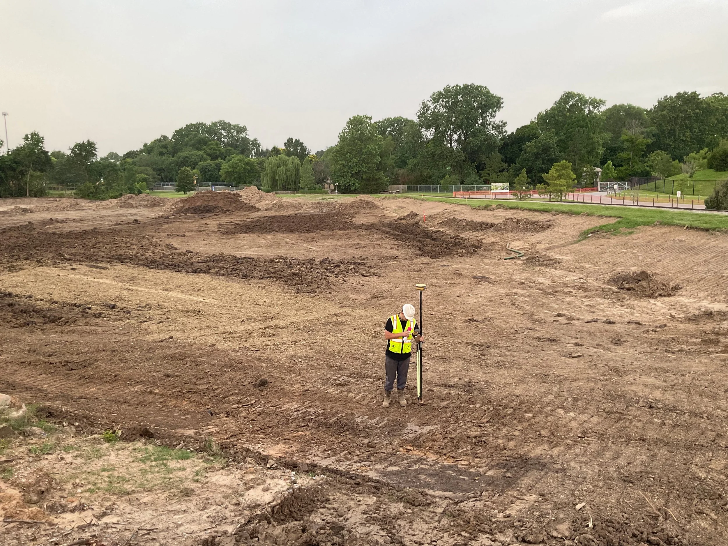 Survey crew staking and evaluating subgrade conditions during early earthwork for the Tulsa Zoo Asian Elephant Exhibit expansion