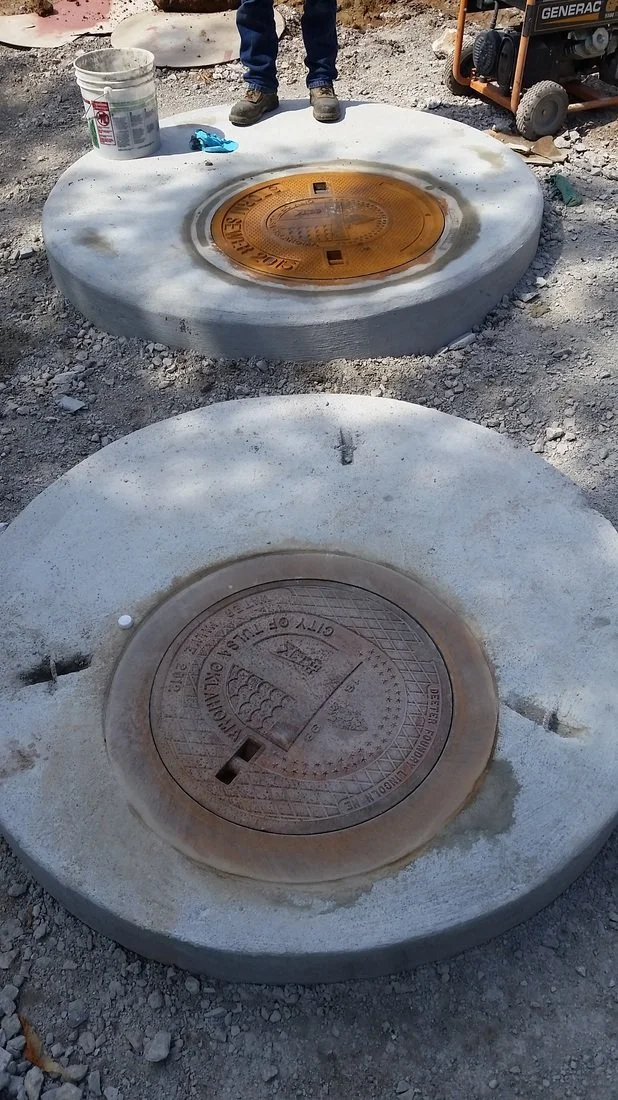 Concrete meter and detector check vault cover installed at ground level.