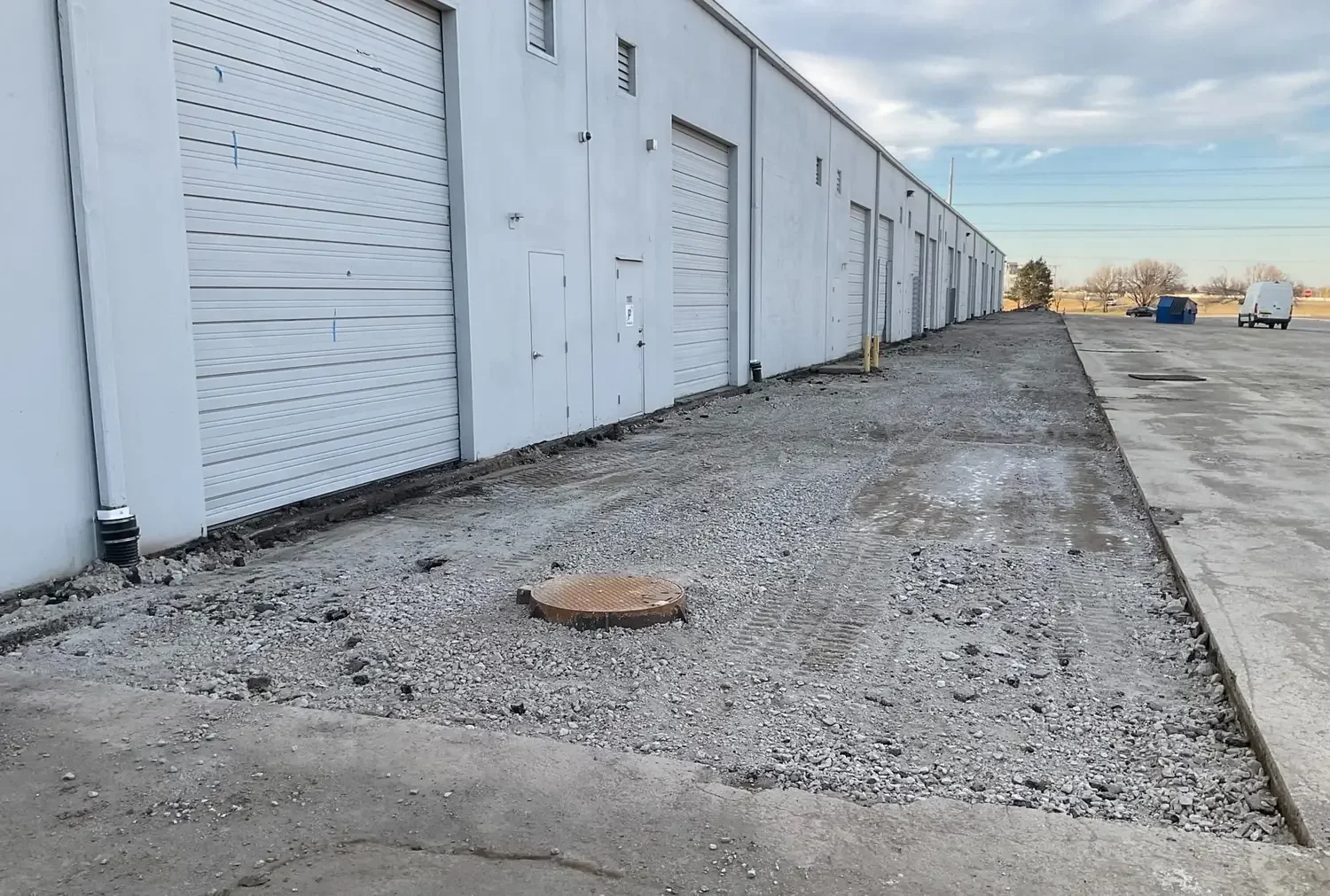 Asphalt demolition and grading for stormwater improvements at active commercial Space Center development