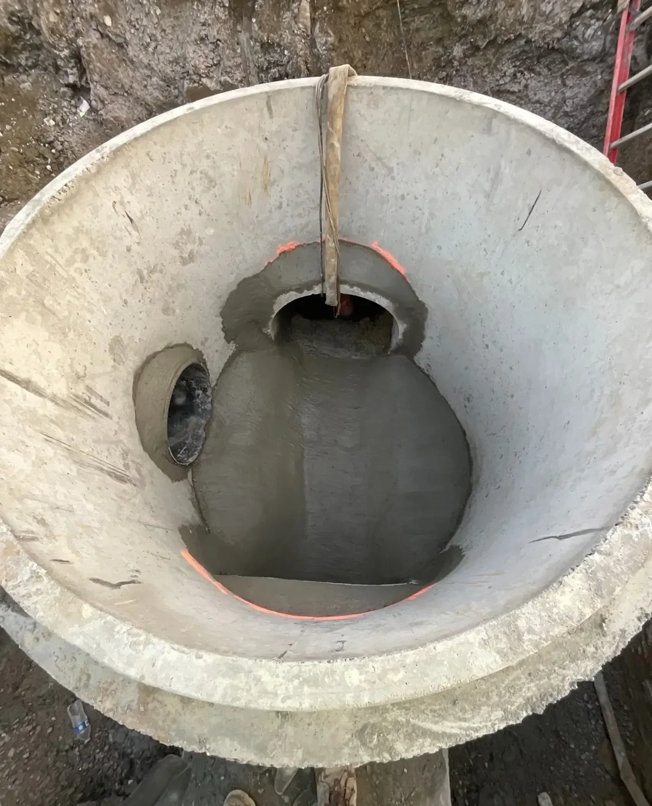 Concrete storm structure with HDPE pipe connections installed for upgraded drainage system at Space Center development