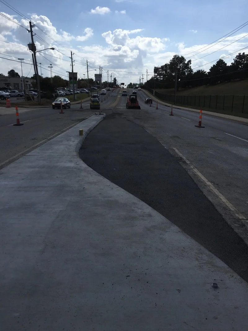 Asphalt and concrete roadway work during surface construction and repair.