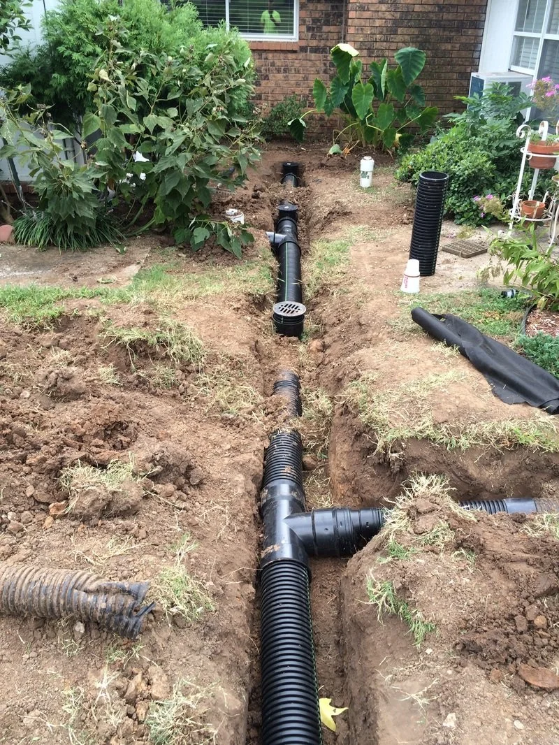 French drain system installed in a trench for subsurface water drainage.