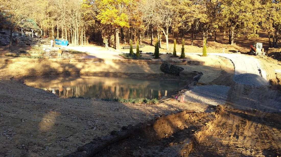 Completed pond excavation showing shaped basin and finished grading.