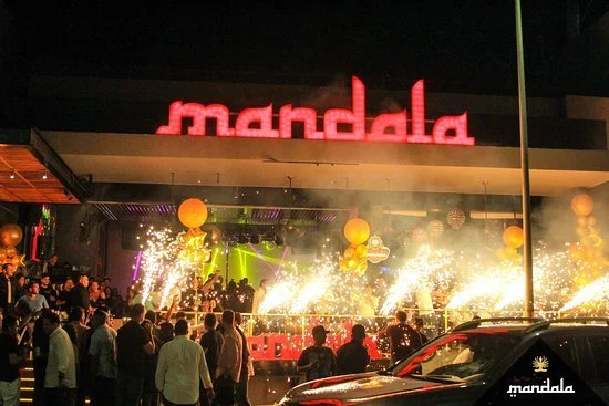 Outside photo of Mandala night club a club right on the mainstream of downtown Cabo. There are SPakrlers going off and people are in line to get in. Vacation rental penthouse Mexico.
