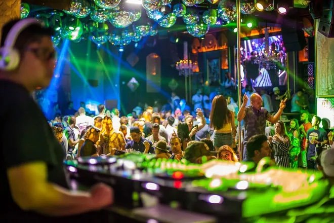 A photo from the perspective of the DJ behind his decks at Madala nightclub. The lights look so fun. Vacation rental penthouse apartment Cabo san lucas. Villa La Estancia. Medano Beach.