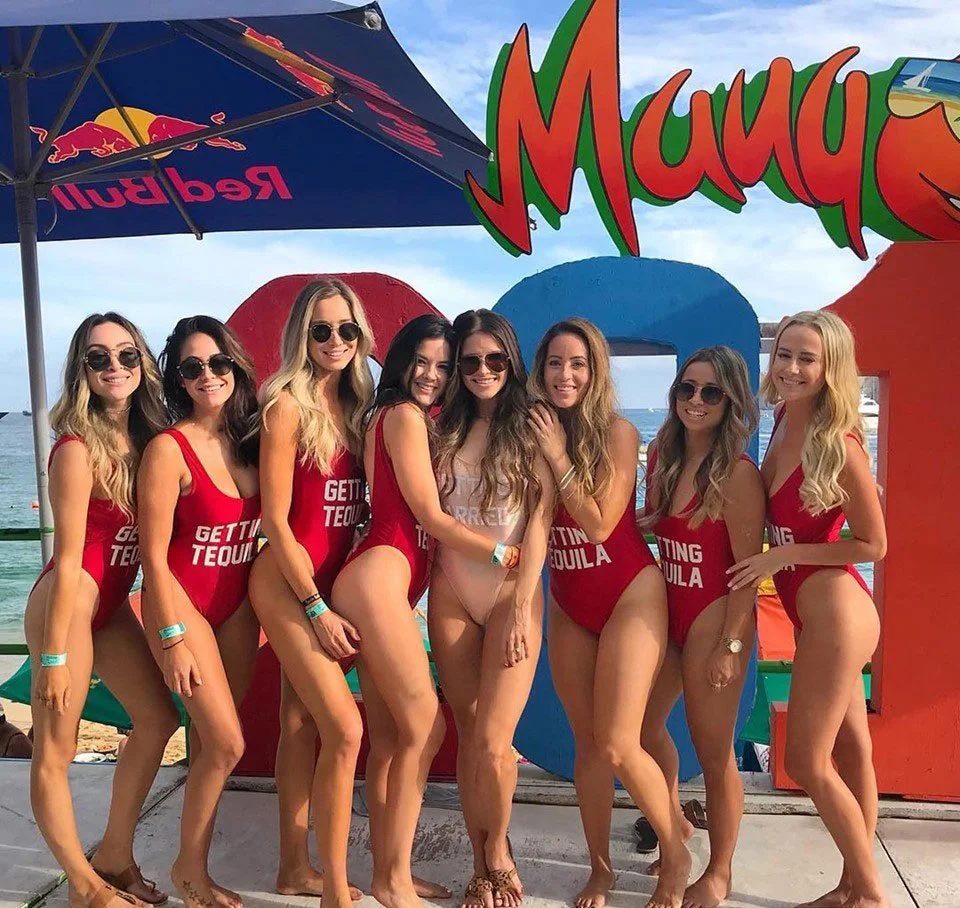 A photo of the packed dance floor at Mandala night club in Cabo San Lucas. There is glitter in the air and the ceiling is filled with shining disco balls. Party goers look like they are having a great time with their hands in the air. Vacation Rental