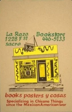 A sign for La Raza Bookstore at 1228 F St, Sacramento, with a phone number 446-5133, featuring yellow and black coloring, and a red text section below stating 'books posters y cosas, specializing in Chicano things since the Mexican American war.'
