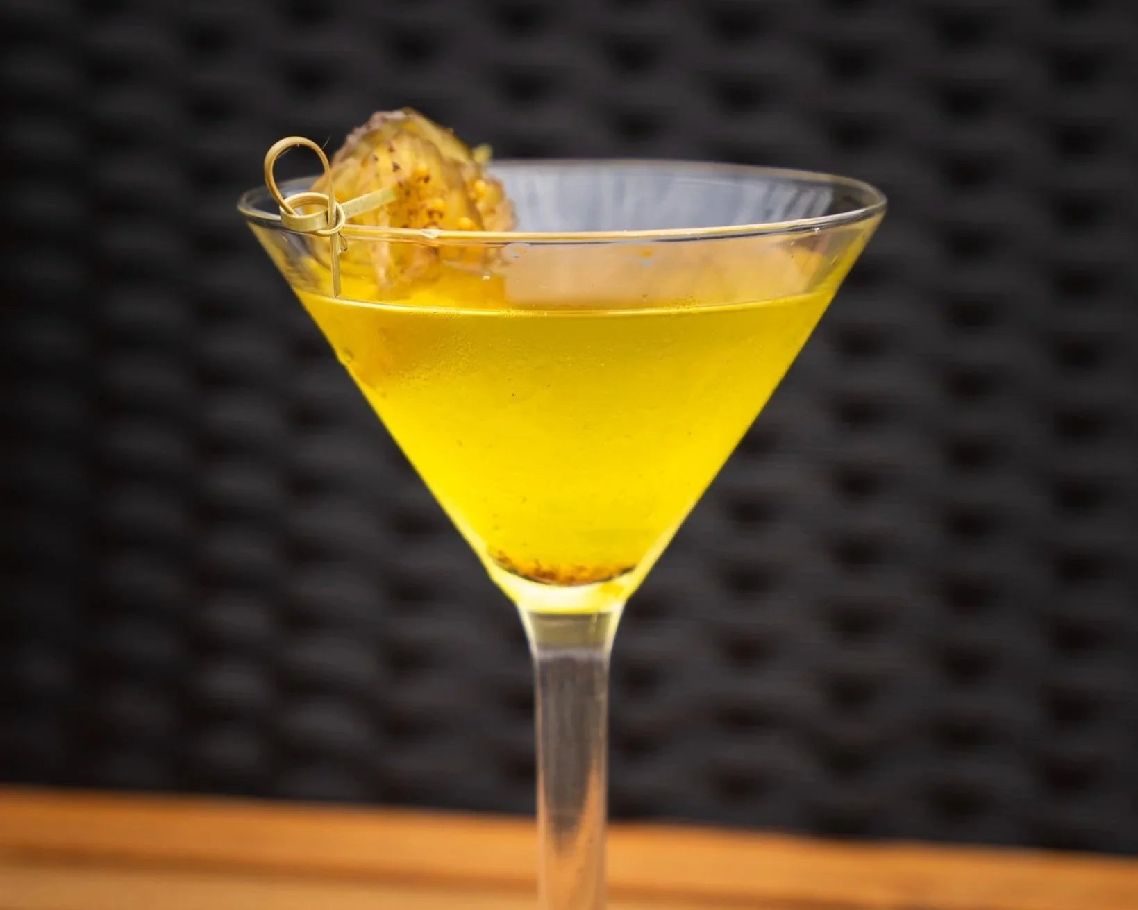 A martini cocktail with olives