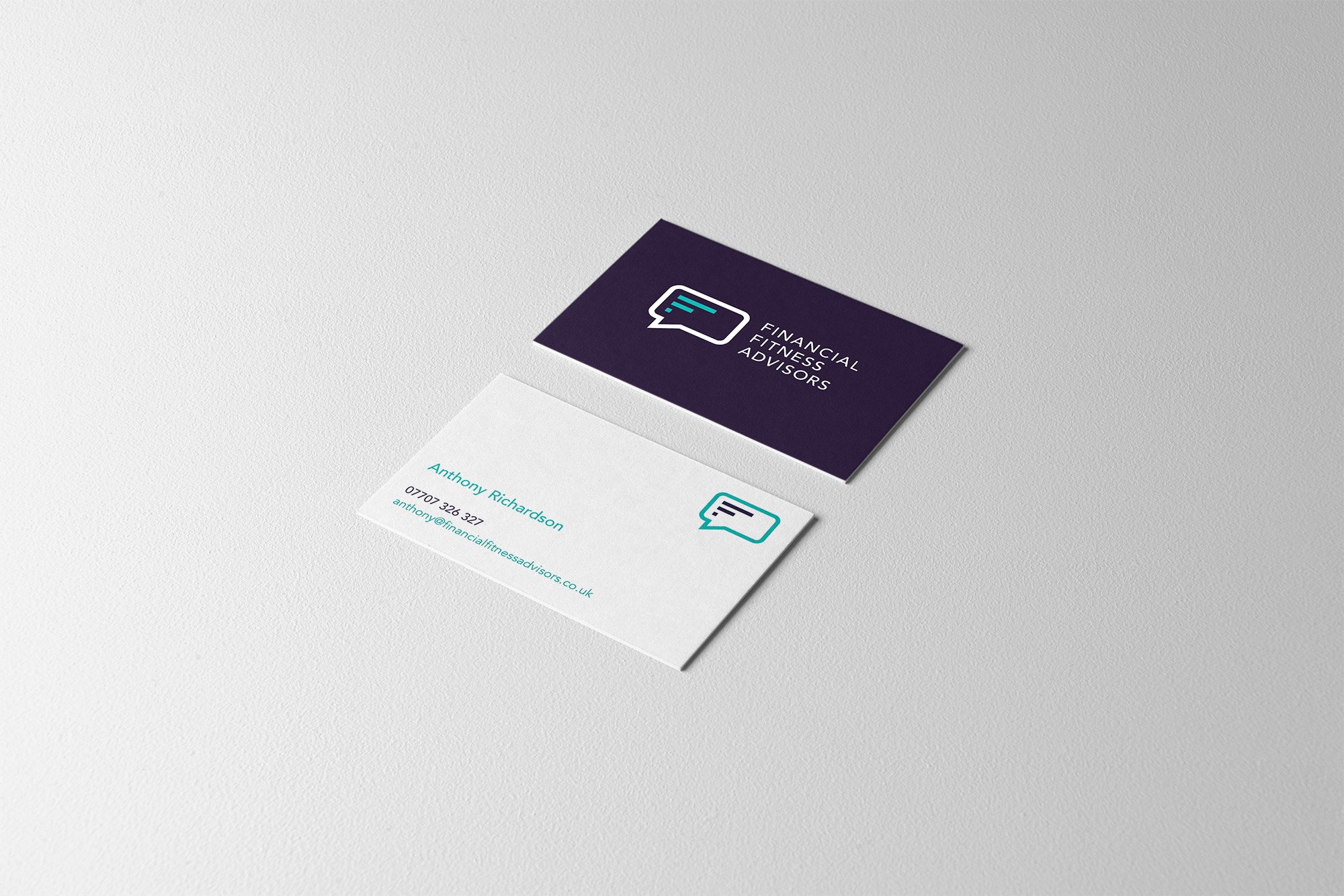 Business cards for Financial Fitness Advisors; one card is dark purple with a speech bubble logo and white text, and the other is white with teal text and a matching speech bubble logo.