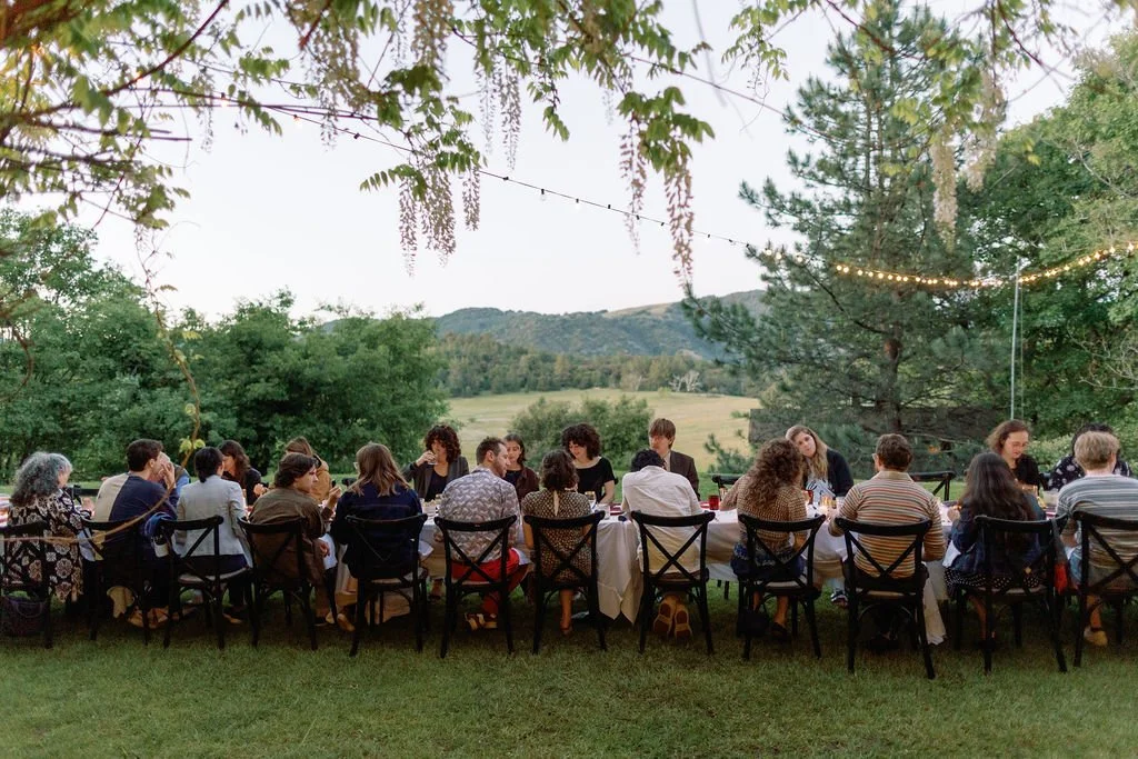 A long table with an intimate group of people sharing a meal at Sacred Mountain Resort in Julian California