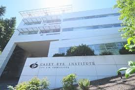 Exterior of Casey Eye Institute building with name and logo, surrounded by greenery