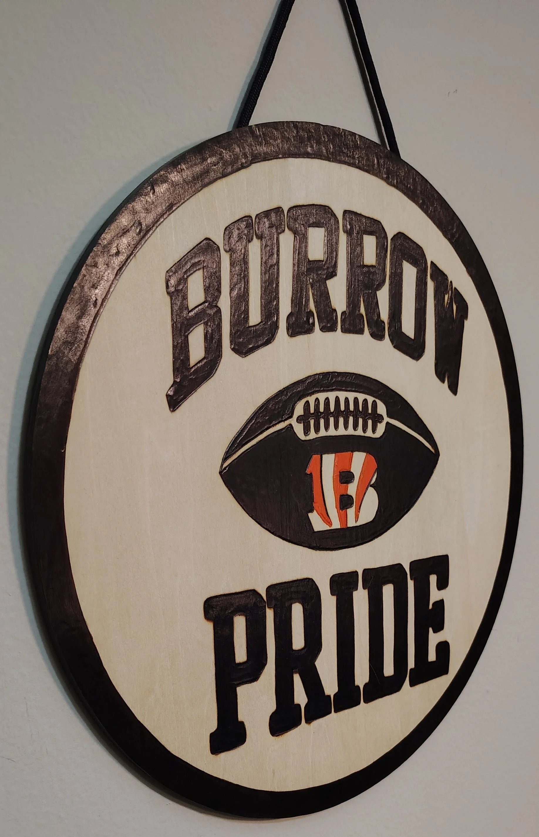 A handmade wood-burned sign of the Joe Burrow Cincinnati Bengals Fan Pride Sign