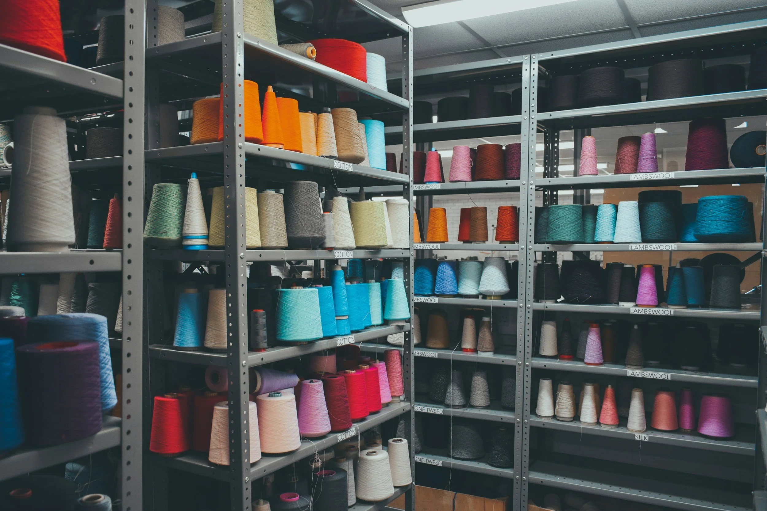 Shelves filled with colorful spools of thread in a sewing supply store.