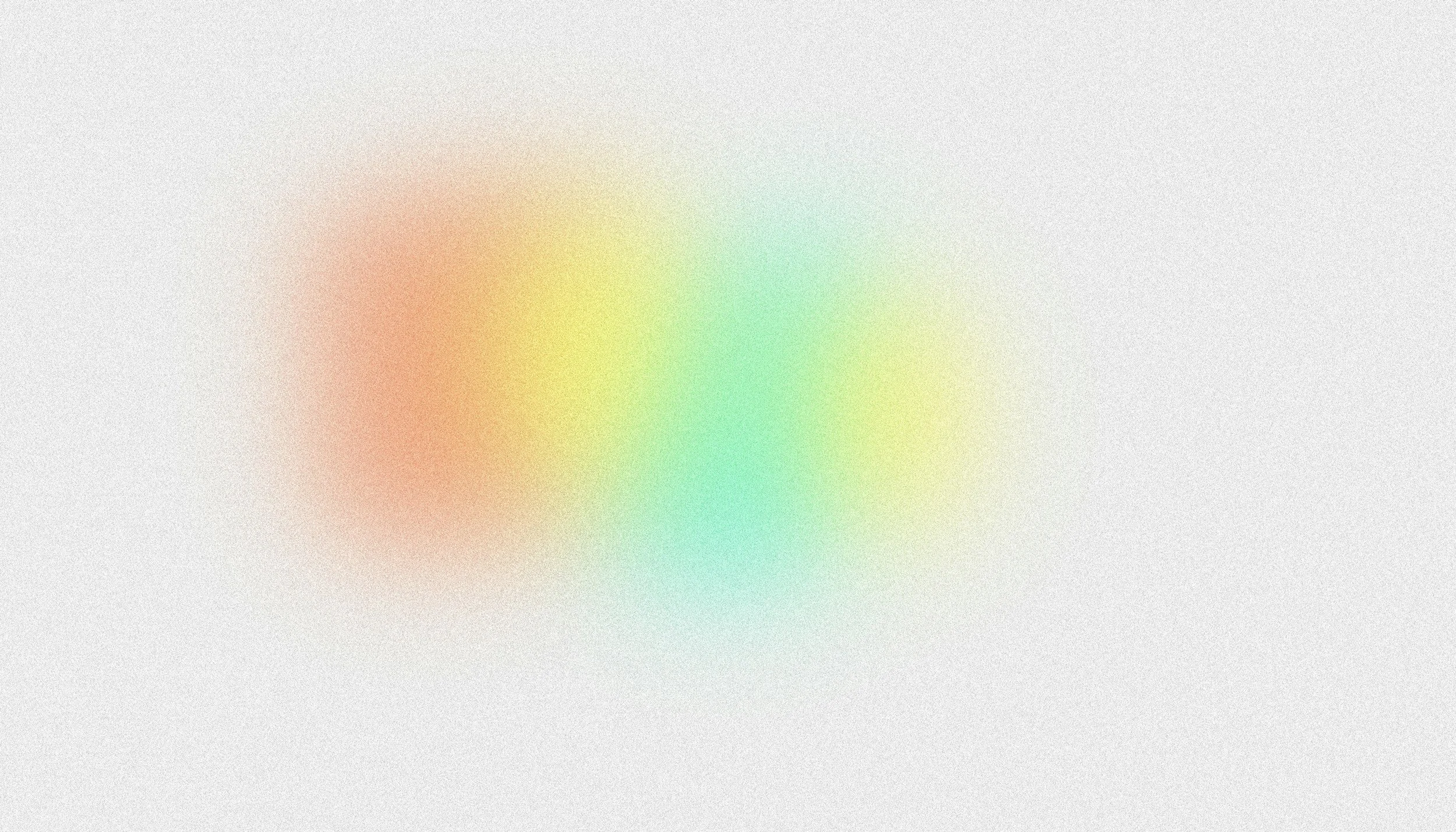 Blurred multicolored background with shades of red, yellow, green, and blue.