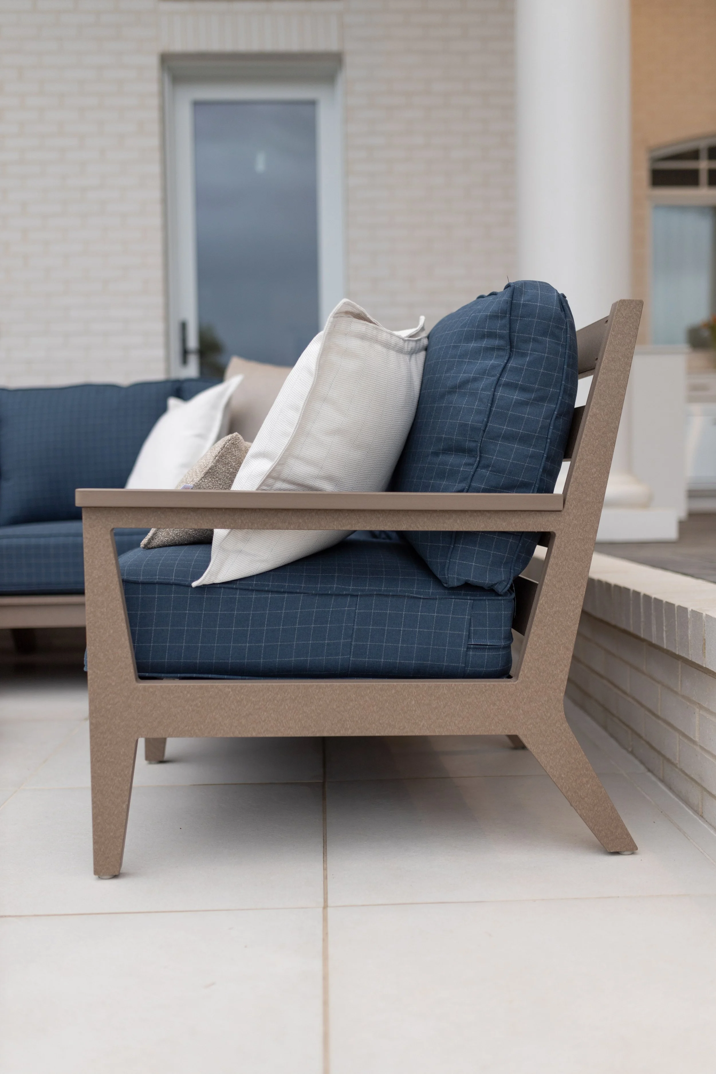 Mayhew Sectional and End Table in Weatherwood. Cushions in Context Indigo. throw pillow in Improve Dune. Additional throw pillows in Kaia Linen.jpg