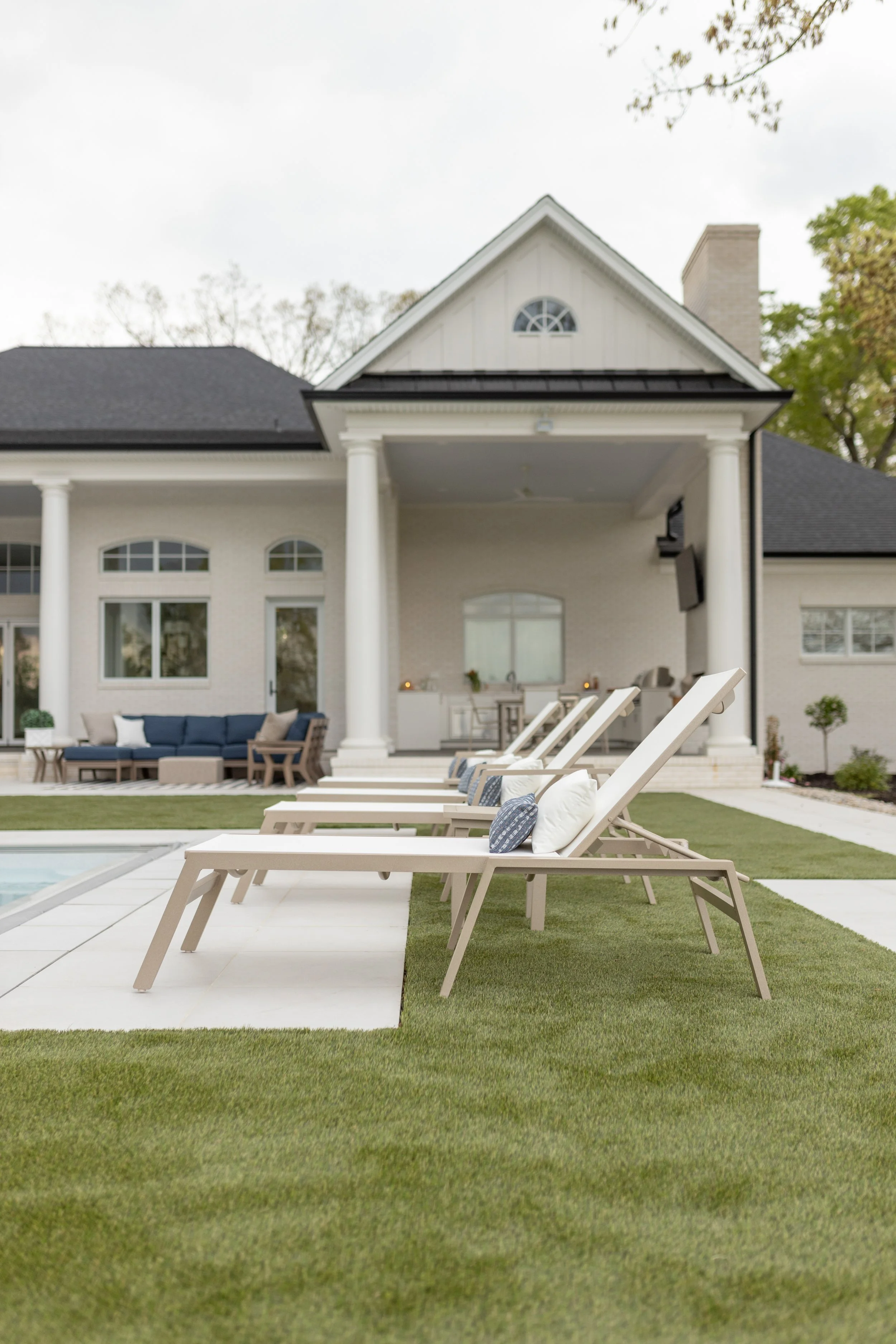 Vida Sling Chaise Lounge, Vida Sling Chaise Lounge with Arms and Vida Dining End Table in Sahara Speckle, sling in Sailing Salt. LilyHive Fitted throw pillows in Canvas Natural and Lyra Denim 2.jpg