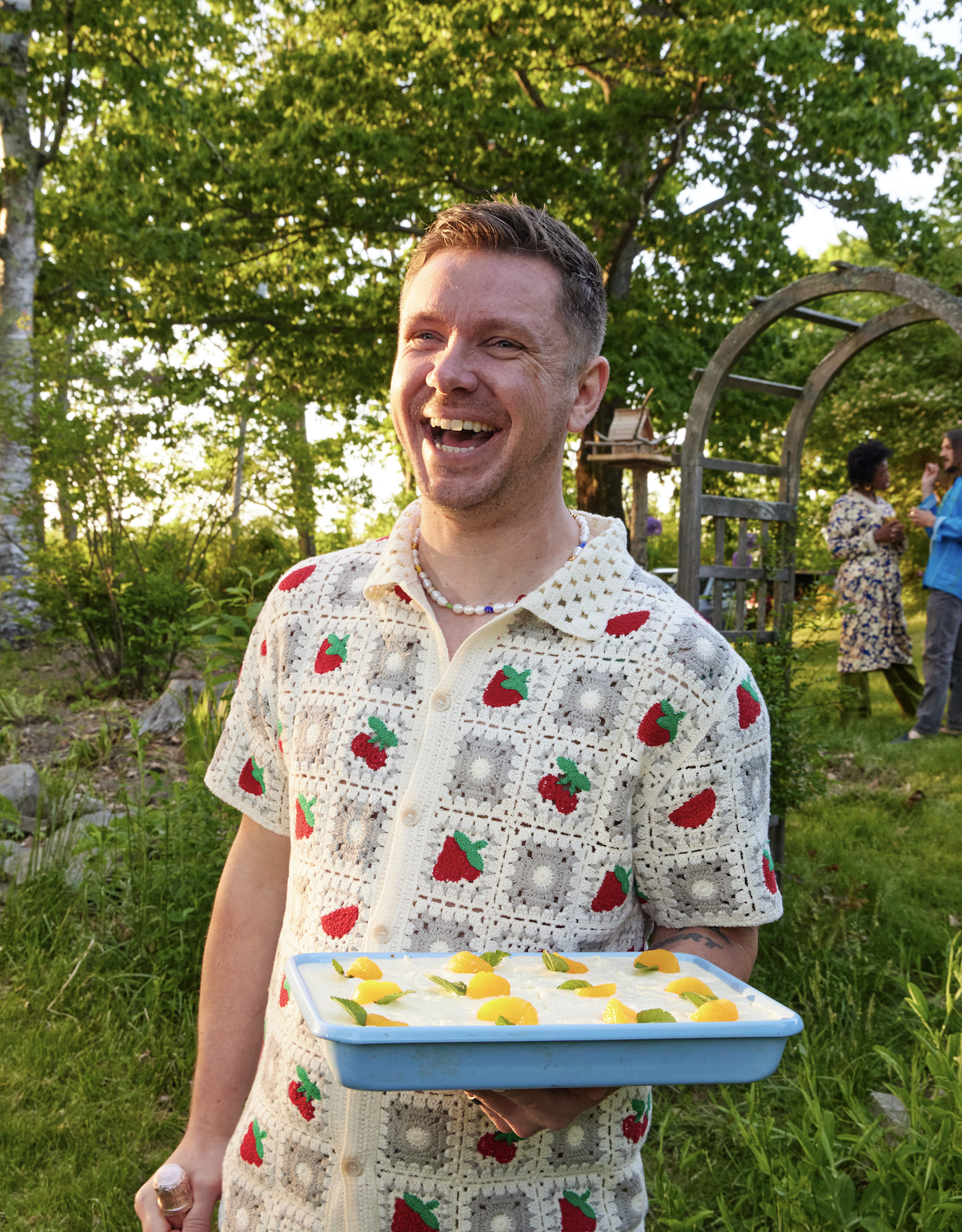 Justin Burke, cookbook author, carrying Shirley's Cake, a recipe from Potluck Desserts cookbook.