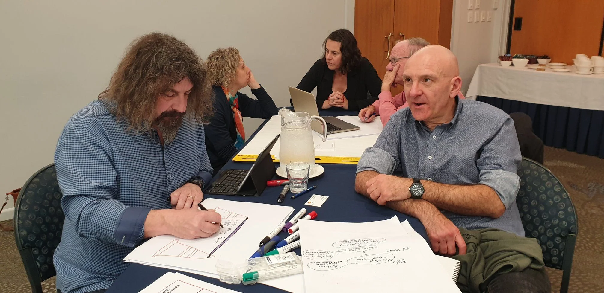 Jonathan Usher sitting at a table with members of PMP