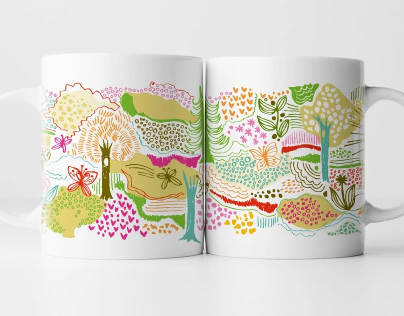 Two white ceramic mugs with colorful, abstract garden landscape designs, featuring trees, butterflies, flowers, and foliage in pink, green, orange, red, and yellow.