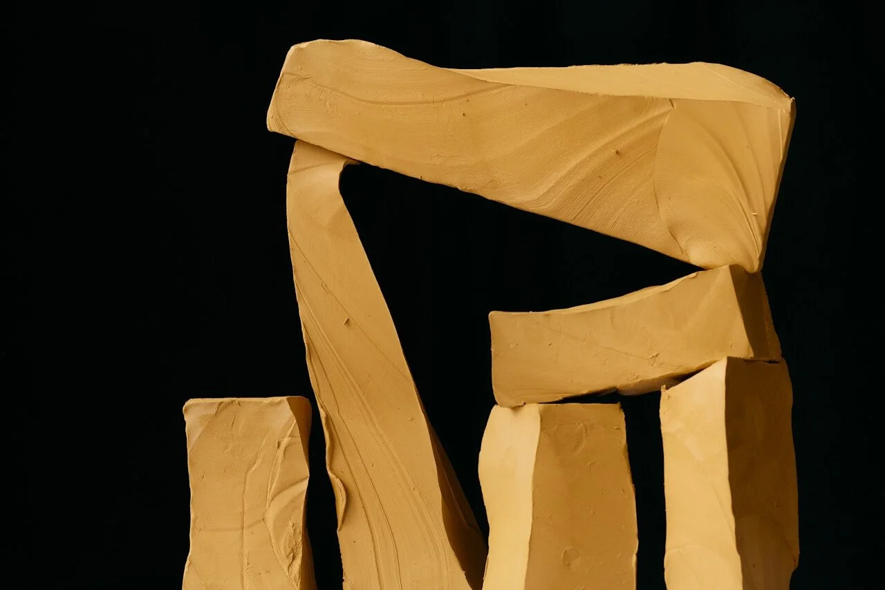 Wooden blocks arranged on a black background, forming a stylized letter 'E'.