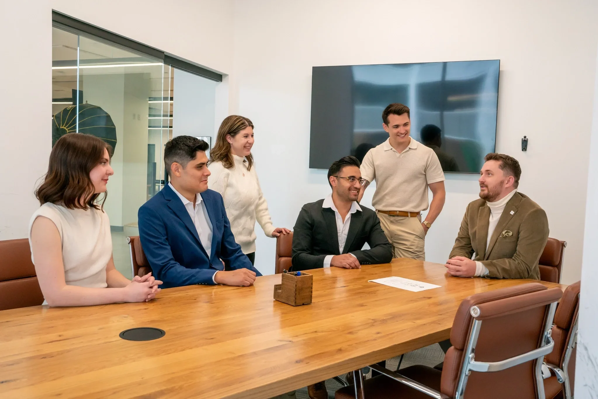Phoenix real estate team from Bryant Real Estate gathered around a boardroom table for a professional group photo.