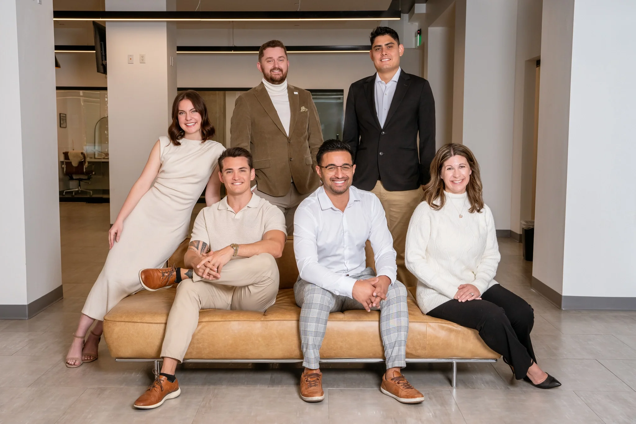 Professional group portrait of the Bryant Real Estate team in a modern Phoenix office.