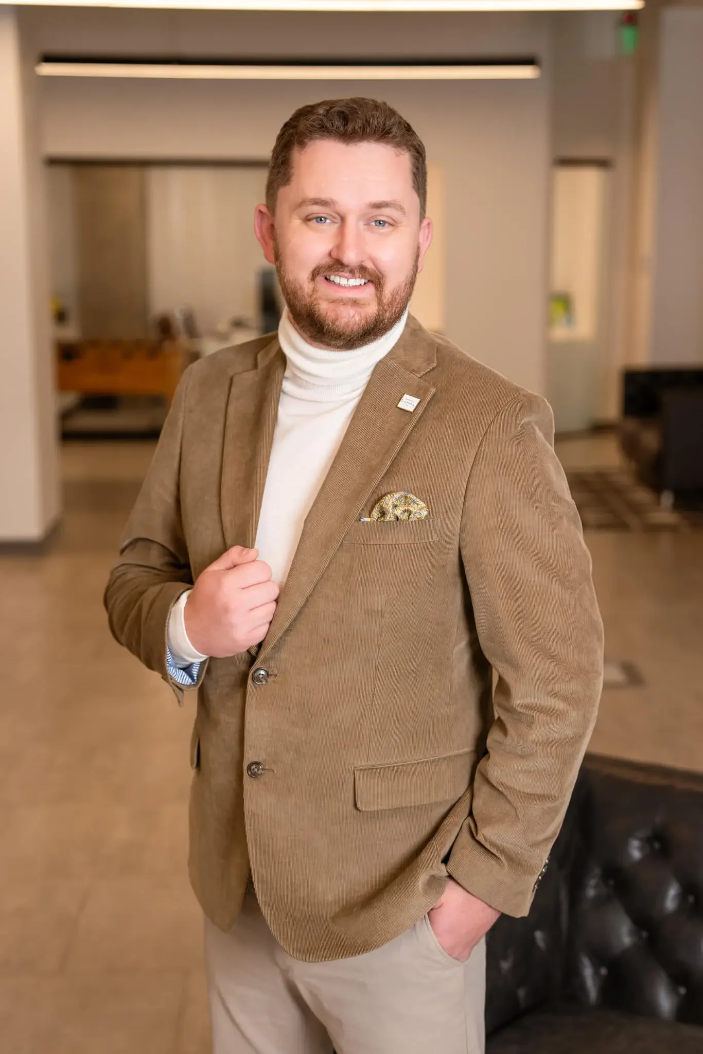 Phoenix Realtor Scott Bryant, founder of Bryant Real Estate, posing in professional luxury attire in a modern Arizona real estate office.