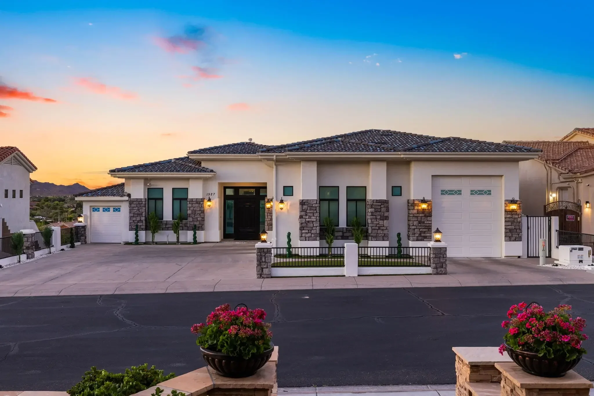 Modern luxury home in Phoenix, Arizona, featuring contemporary architecture and desert landscaping at sunset, representing Bryant Real Estate listings.
