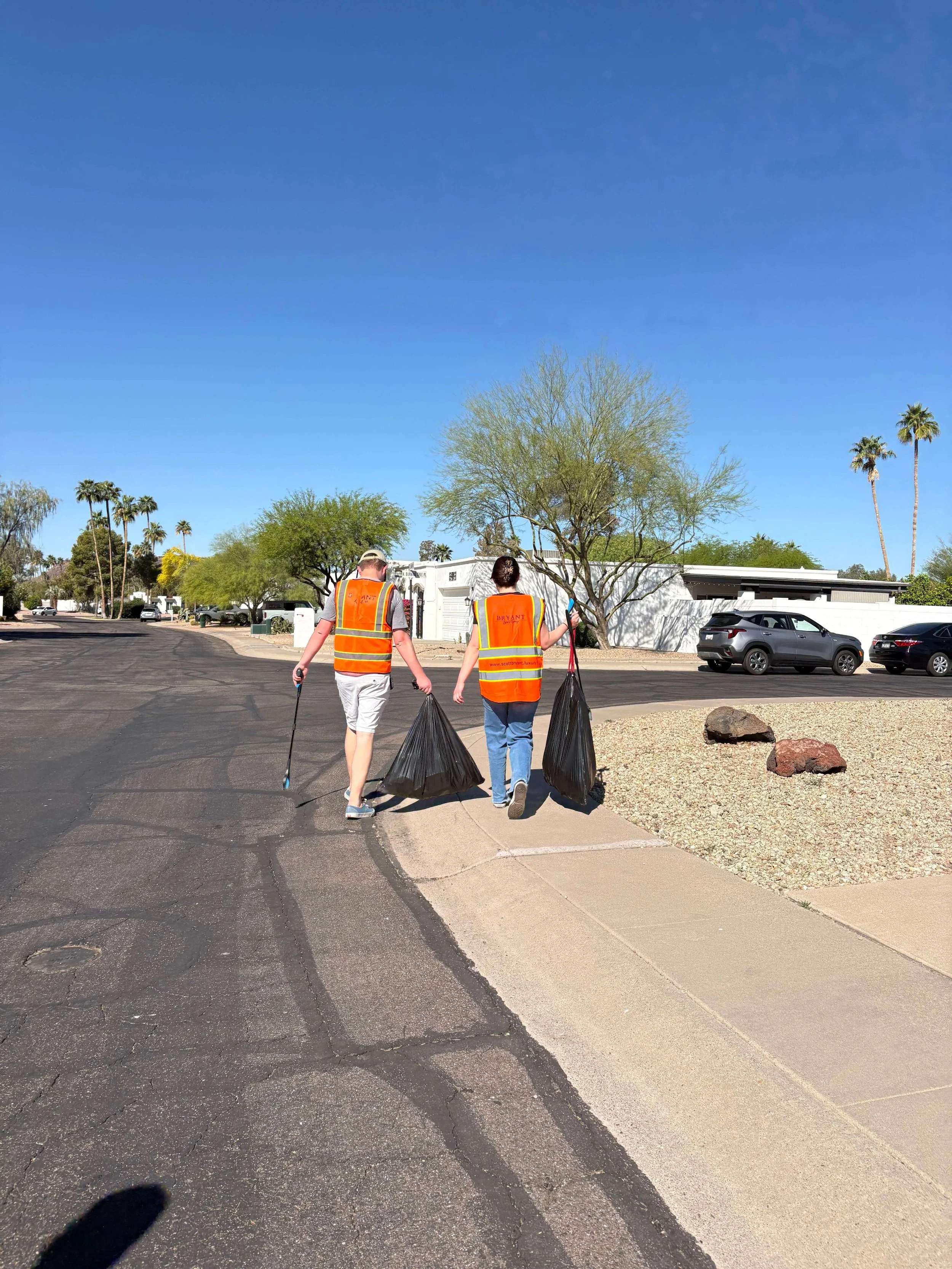 The Bryant Real Estate team participating in a local neighborhood cleanup volunteer event in Phoenix, Arizona.
