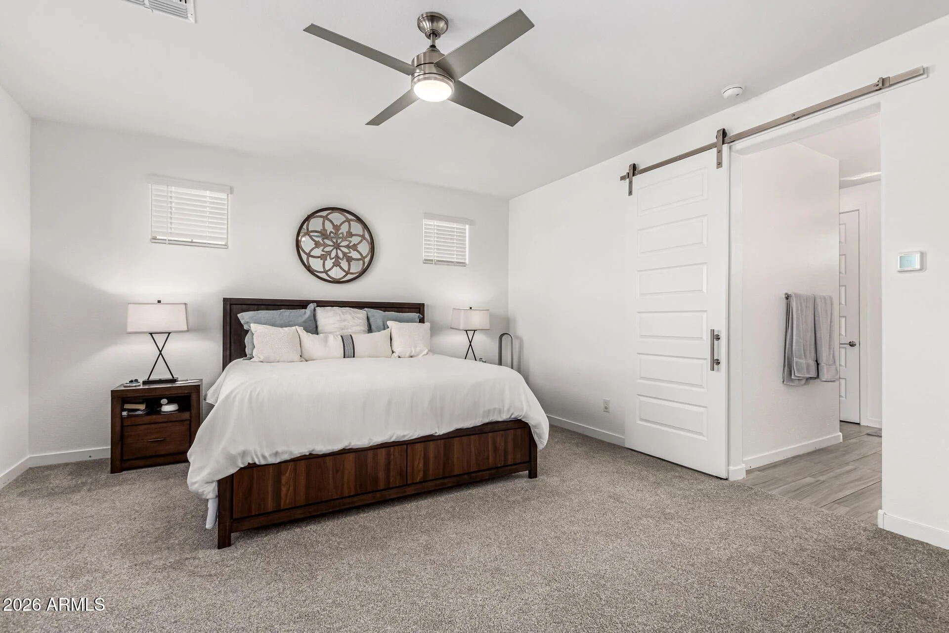 Primary bedroom in a Chandler, Arizona home for sale featuring neutral tones, modern finishes, ample natural light, and a spacious layout