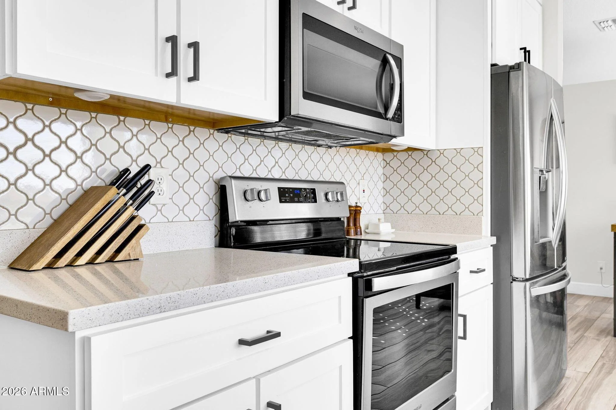 The updated kitchen features modern quartz countertops and continuous sightlines, meeting the demand for move-in ready interiors in North Central Phoenix.