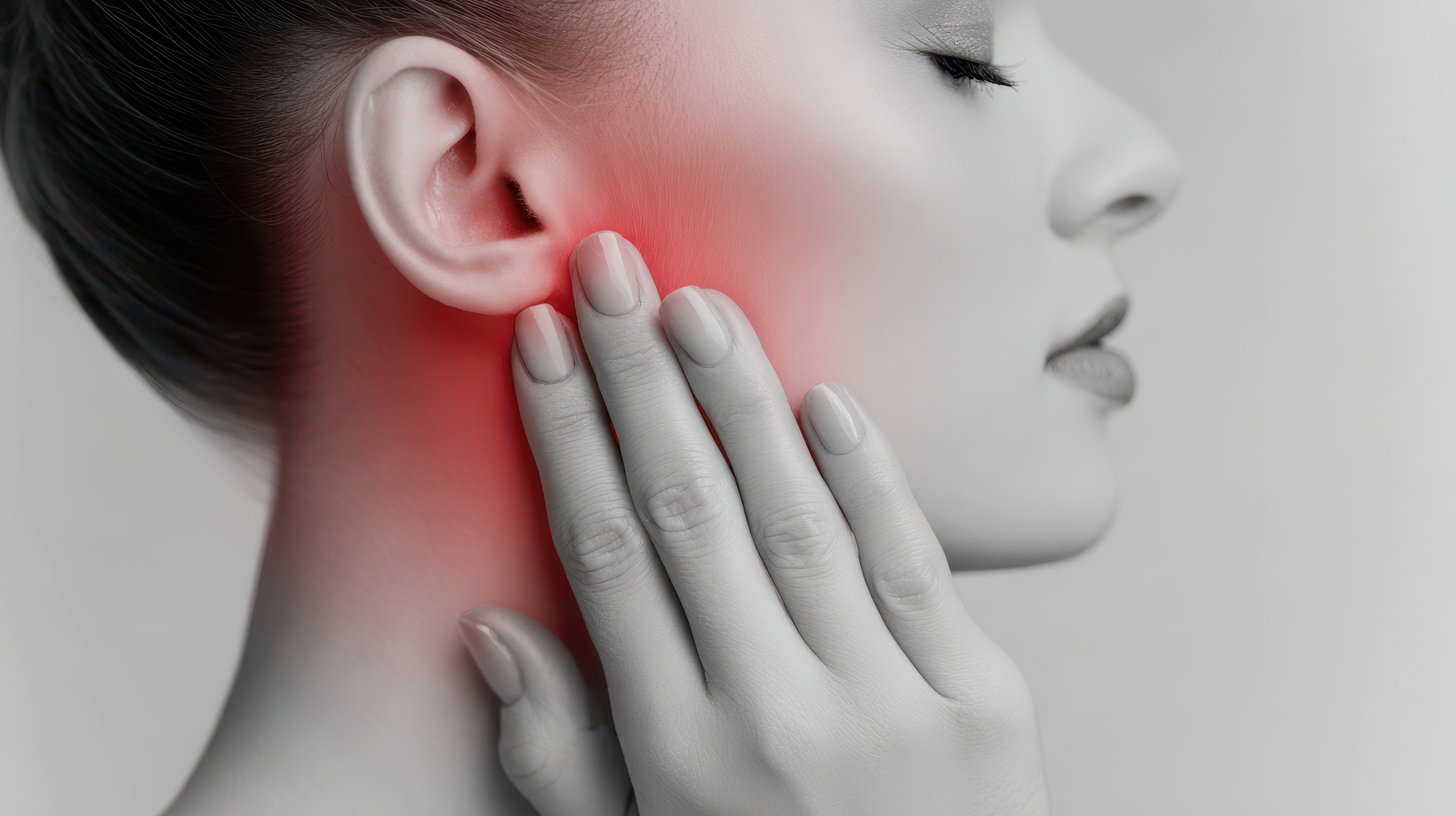 Close-up of a woman touching her jaw with her hand, indicating pain or discomfort in her jaw or neck area, with a red highlight on her neck suggesting inflammation or pain.