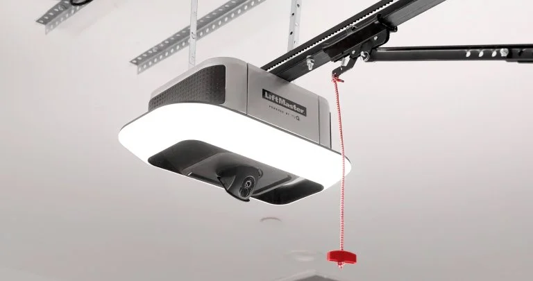 An installed LiftMaster garage door opener with light illuminated