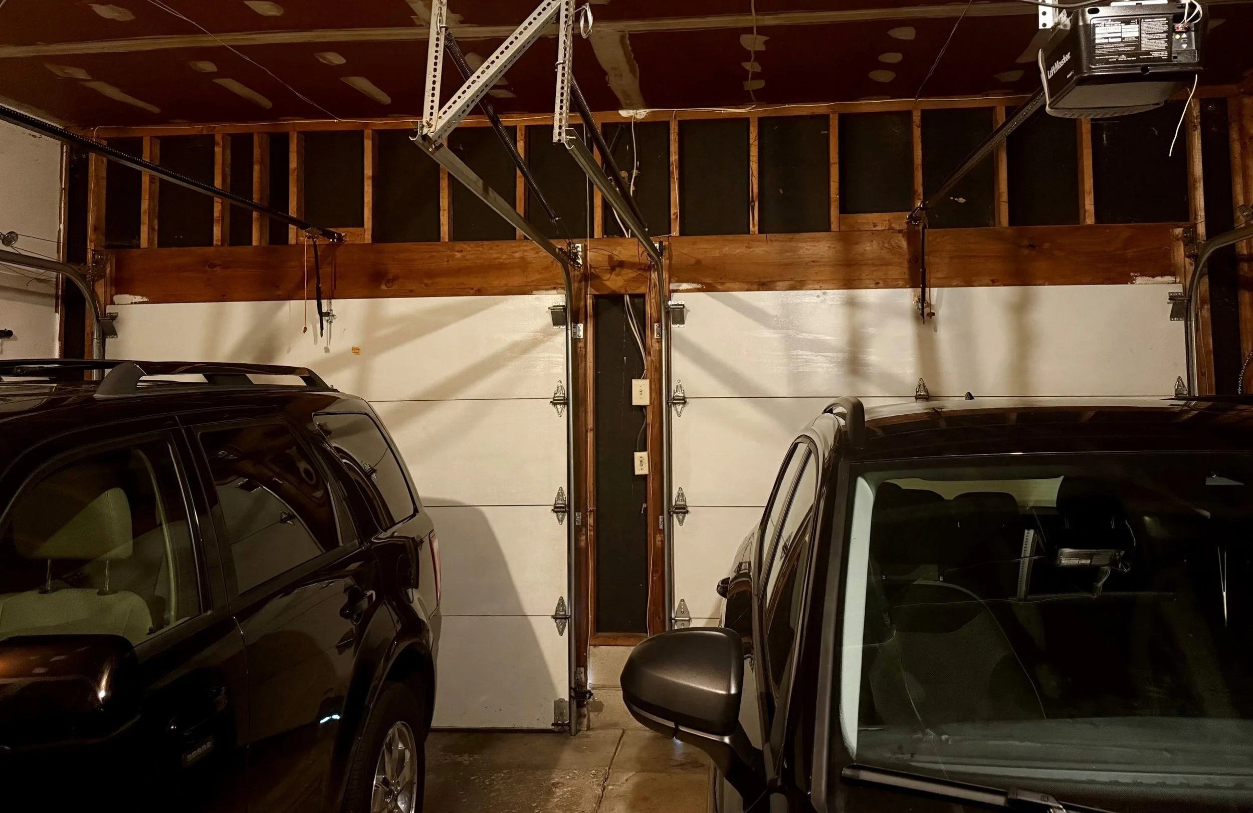 Before Replacement: Interior of 2 side-by-side 8-by-8 foot garage doors