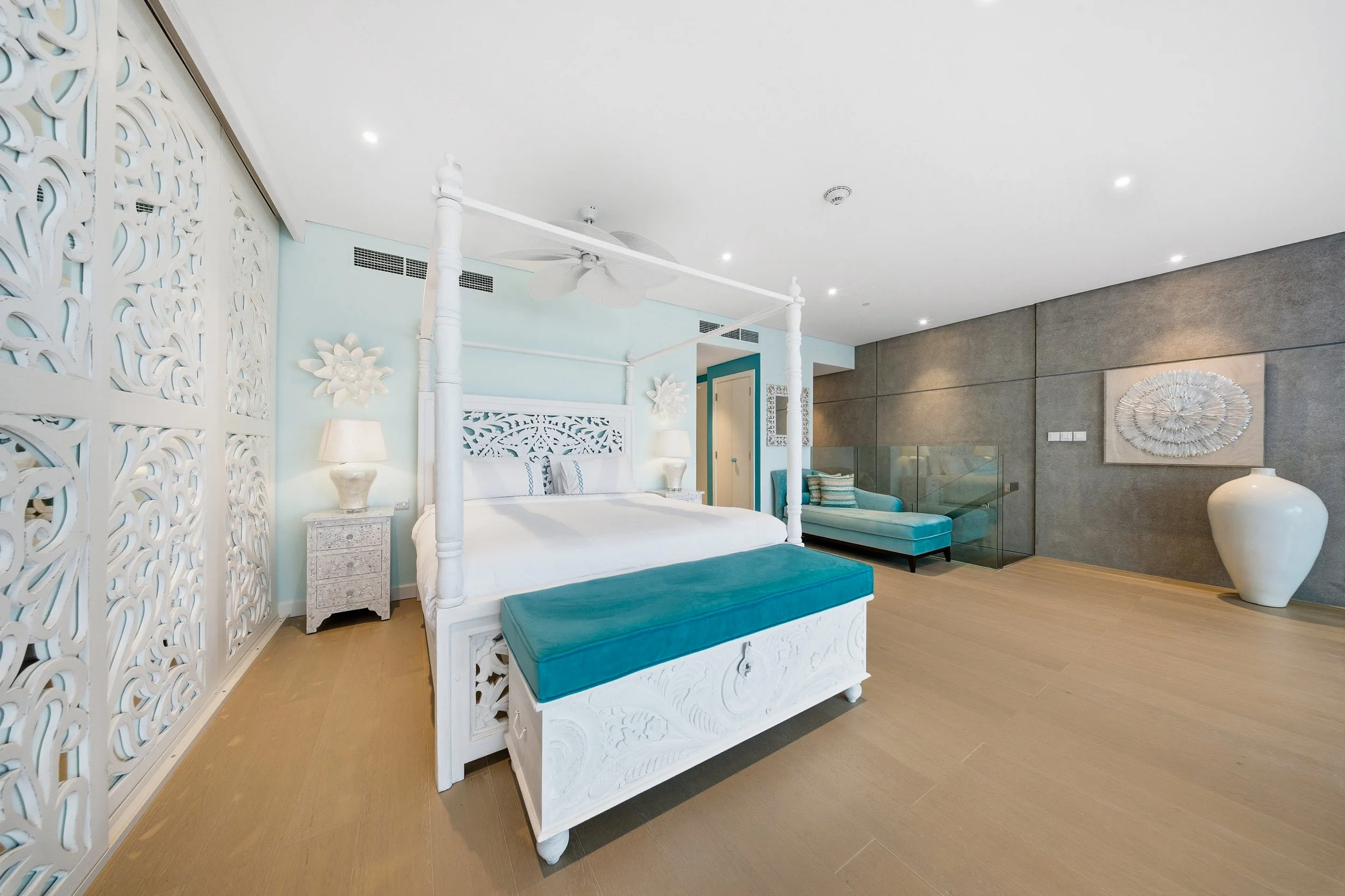 Four-poster centrepiece with bespoke carved details.